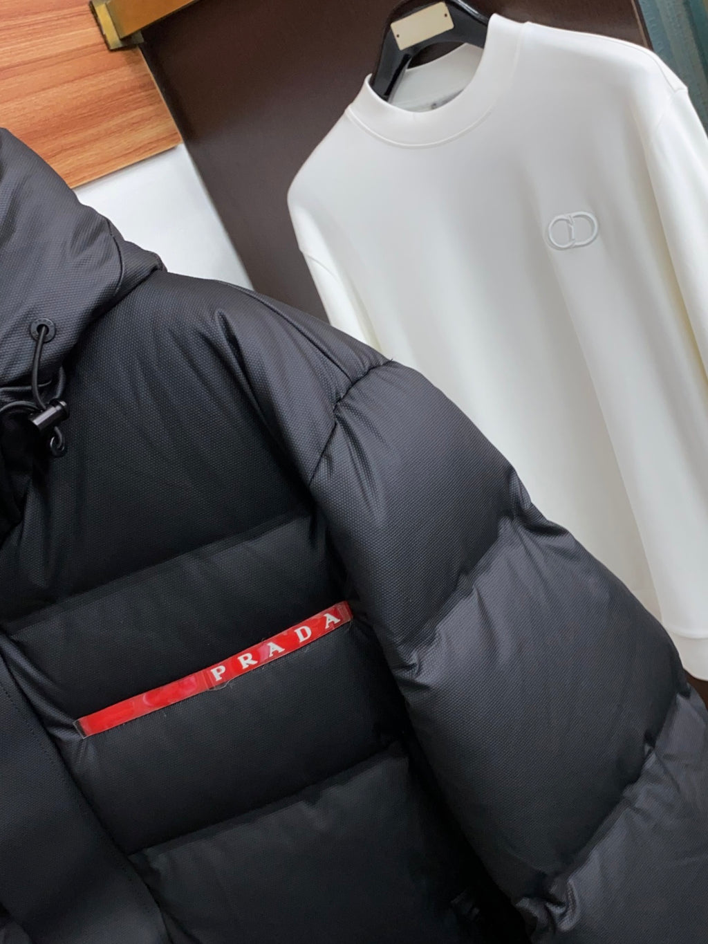 PRADA Black Hooded Down Jacket | Signature Red Accent & Modern Cold-Weather Style