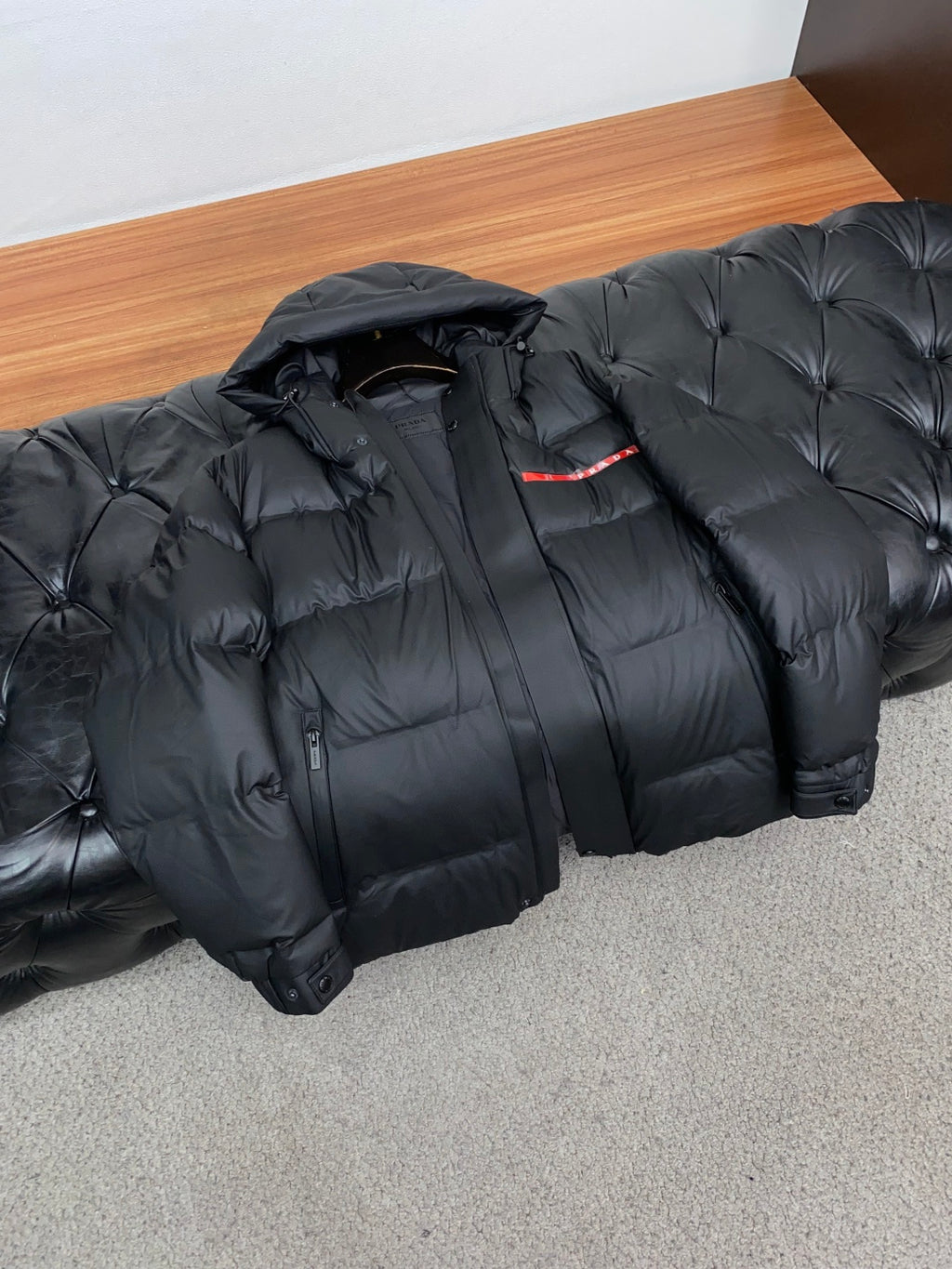 PRADA Black Hooded Down Jacket | Signature Red Accent & Modern Cold-Weather Style